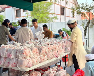 Volunteers at Masjid Alkaff Upper Serangoon preparing and distributing food packages for community donation drive